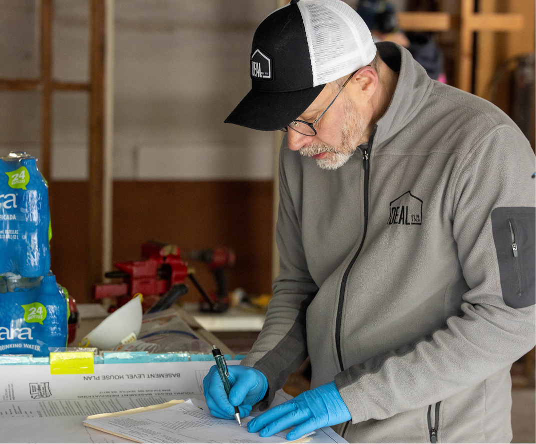 Team member reviewing construction paperwork at a job site