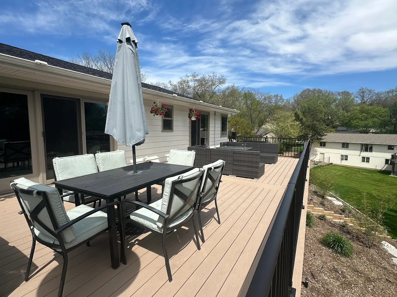 Completed elevated composite deck with outdoor dining furniture