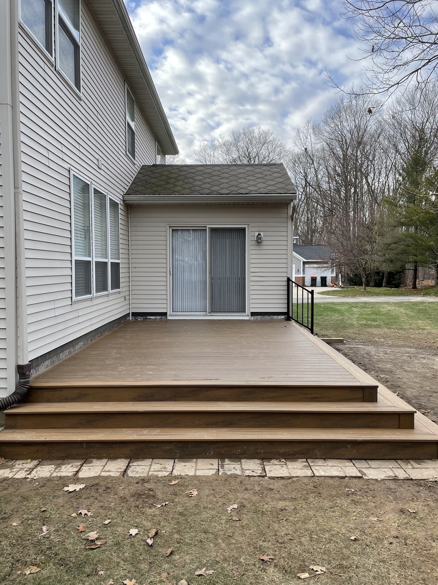 Ground-level composite deck with wide steps